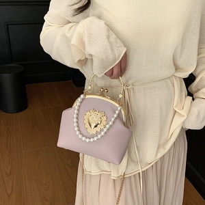 Lavender shell bag with golden heart motif, pearl strap and metallic top handle