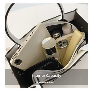 Detailed interior view showing large capacity for tablet, wallet and cosmetics in tote bag