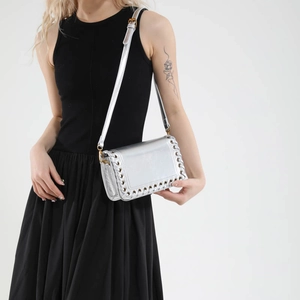 Metallic silver woven shoulder bag with eyelet details and adjustable strap for women