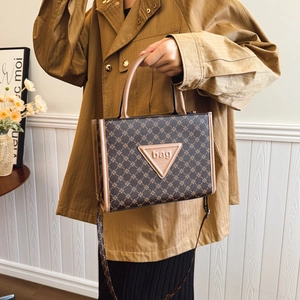Large capacity vintage printed tote bag with brown leather tag shown in interior setting