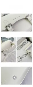 Close-up of white lychee leather texture and silver metal hardware on saddle bag