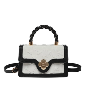 Chic monochrome crossbody bag with white embossed texture and gold floral clasp lock