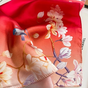 Silk neck scarf featuring floral magnolia and bird print in vibrant pink gradient colors