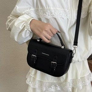 Classic black lychee texture saddle bag with silver buckles and crossbody strap