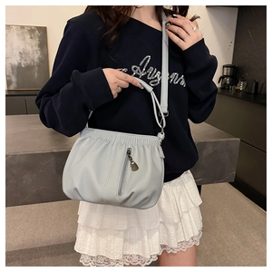 Litchi texture PU leather bucket bag featuring front pleats and vertical zipper detail