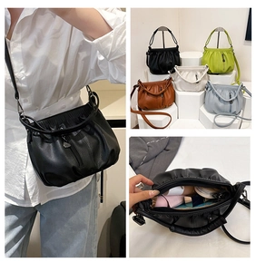 Detail view of cloud crossbody bag showing multiple colors and spacious interior capacity