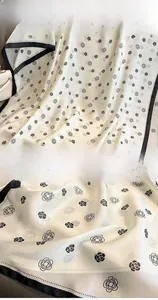 Detail of silk-like camellia scarf showing high-quality hem stitching and soft texture