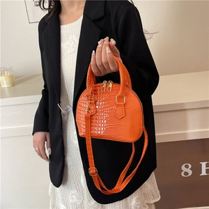 Bright orange crocodile pattern shell handbag with gold zippers and long strap
