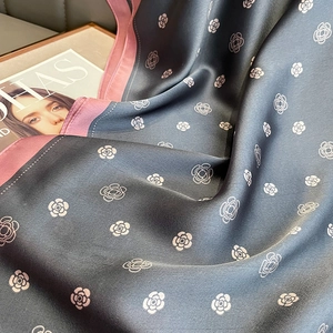 Detail of camellia silk scarf in dark gray and pink showing soft texture and drape