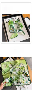 Detailed view of floral oil painting silk scarf with premium hand-rolled edges