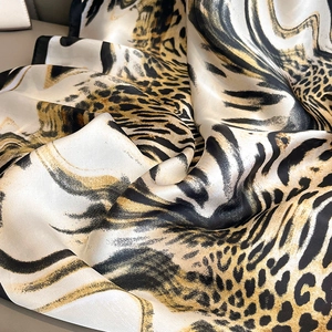 Elegant leopard and zebra print silk scarf in beige and gold tones with a soft sheen