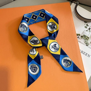 Silk-feel geometric scarf with dog print on bright orange luxury gift box setting