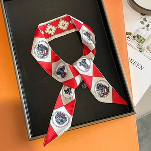 Detail of red and grey twilly silk scarf featuring hand-drawn dog portrait illustrations