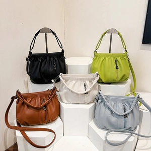 Modern pleated leather bucket bags in multiple colors with vertical zipper and shoulder straps