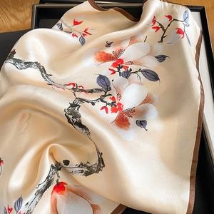 Elegant mulberry silk scarf featuring floral patterns on champagne satin fabric