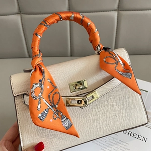 Elegant cream leather handbag with orange floral silk scarf wrapped on single handle