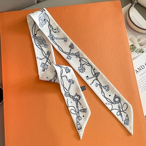 Elegant white skinny silk scarf with vintage key patterns on a bright orange background