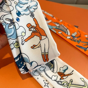 Detail of silk twilly scarf with illustrative gentleman and anchor prints on orange background