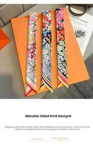 Detail von 5x85cm floralen Twill-Seidenschals auf einer eleganten orangefarbenen Box