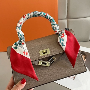 Brown crossgrain leather handbag with floral silk scarf wrapped on top handle