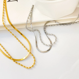 Close-up of double-layer snake and bead chains in polished gold and silver finishes