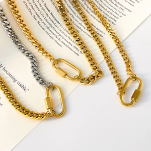Detailed macro of gold and silver chunky chain necklaces with large spring oval clasps