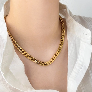 Close-up of gold-plated double-layer curb chain necklace worn on a neck model