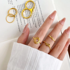 Golden titanium steel ring set featuring sunflower, twisted knots, and MAMA letter designs