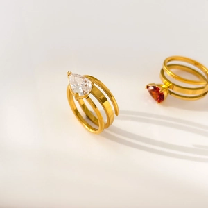 Macro detail of gold-plated double-layer rings with teardrop zircon stones