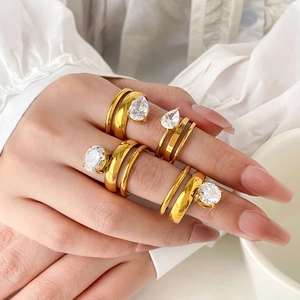 Detail showing a set of four gold titanium rings with pear and round cut zircons