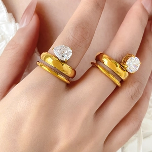 Detailed close-up of gold double-layer titanium rings with teardrop and round zircon stones