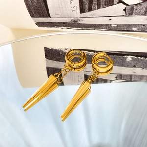 Close-up of gold plated stainless steel teardrop earrings reflecting on a mirror