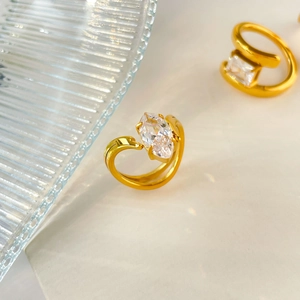 Macro detail of 18K gold-plated titanium ring with marquise-cut zircon on glass tray
