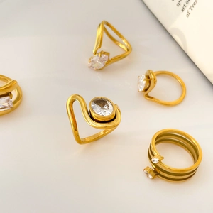 Detail of 18K gold-plated titanium rings set featuring geometric zircon stones and crystals