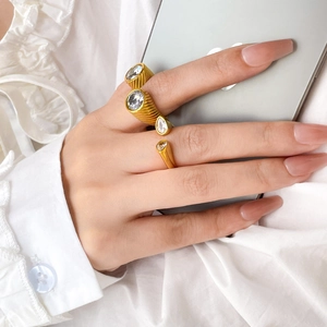 Close-up of 18K gold plated snake-style rings with zircon stones worn on hand