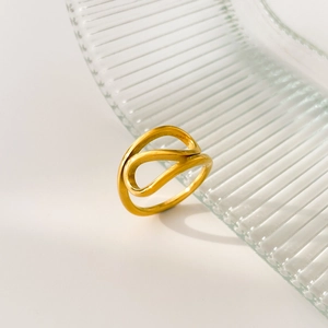 Macro detail of curved 18K gold plated titanium ring with minimalist wave line design