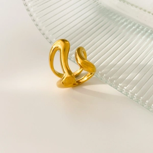 Artistic detail of gold 18K plated stainless steel ring with curved wave design and glossy finish