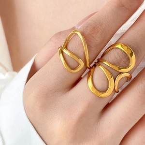 Macro shot of 18K gold plated curved line ring featuring abstract geometric cutouts