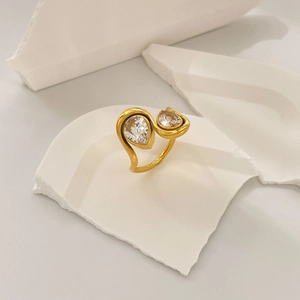 Detail of 18K gold plated steel ring featuring two sparkling pear-cut cubic zirconia stones