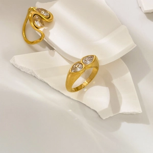 Detail of 18K gold-plated titanium rings featuring teardrop cubic zirconia settings
