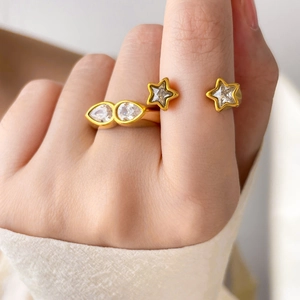 Gold plated titanium steel ring featuring teardrop and star-shaped cubic zirconia stones