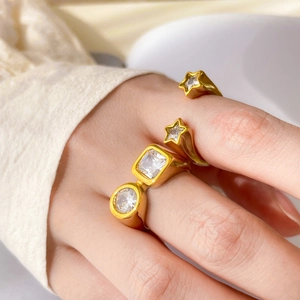 Macro view of gold plated titanium steel rings set with zircon star and eye shapes