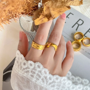 Polished 18K gold plated titanium ring with textured honeycomb pattern and wide arc band