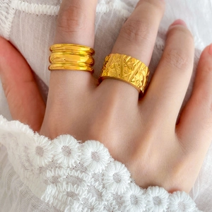 Detail of 18K gold plated titanium rings with diagonal diamond and triple arc patterns