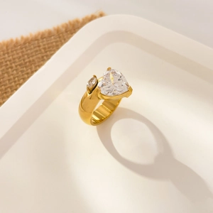 Macro view of wide 18K gold-plated band ring with large heart-shaped clear zircon stone