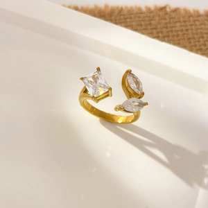 Detailed close-up of 18K gold plated ring featuring emerald and marquise-cut cubic zirconia
