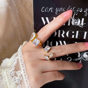 18K gold plated titanium rings set with square and teardrop zircon on a model's hand