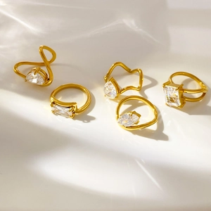 Detail of 18K gold plated ring set with white zircons in pear and rectangle cuts