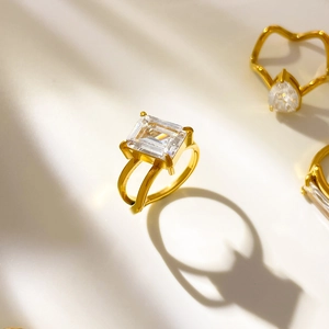 Macro view of 18K gold plated rings with emerald cut and teardrop cz stones details