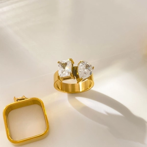 Detail of 18K gold plated double ring featuring teardrop and emerald cut zircon stones